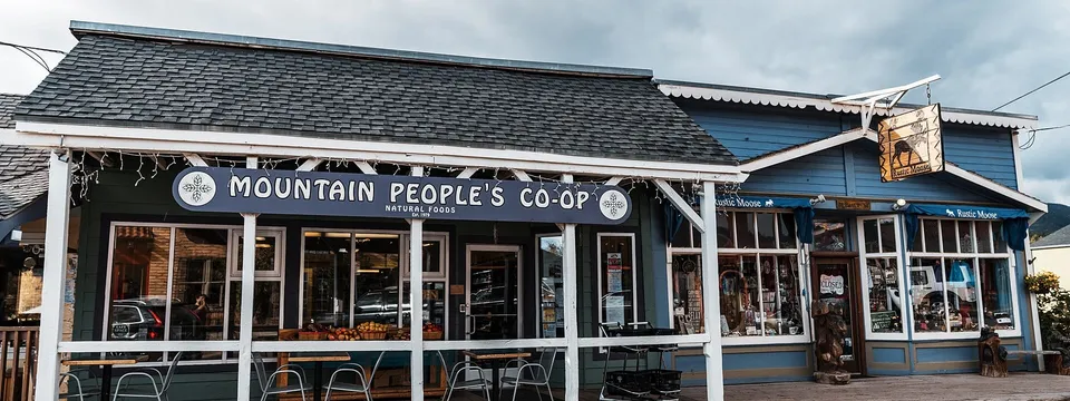 Mountain People’s Co-op and the Rustic Moose on East First Street in Nederland, under a grey mountain sky